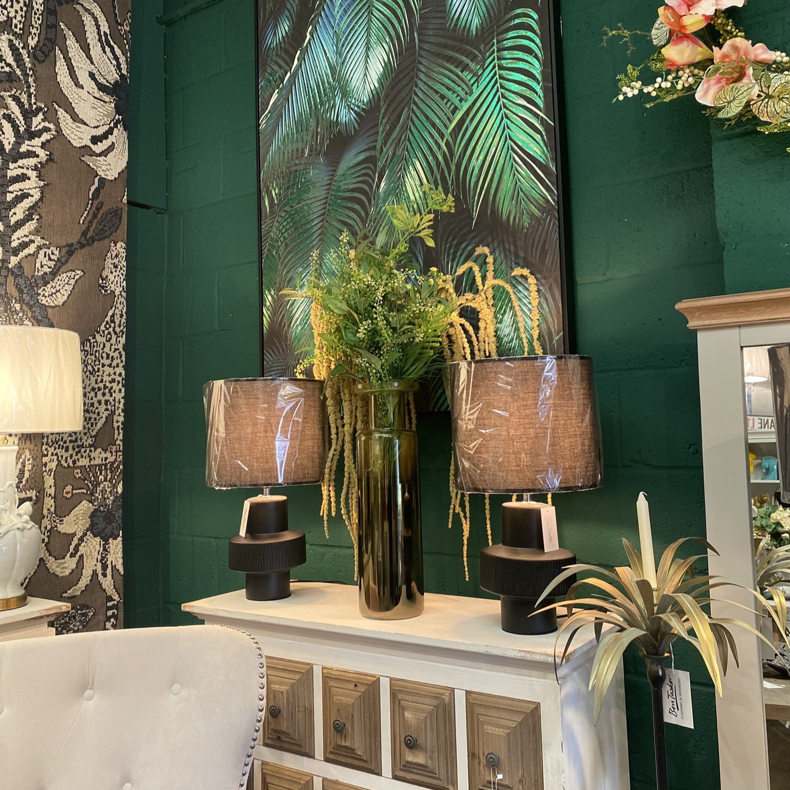 ambient lighting with two lamps next to a designer vase in a modern lounge.