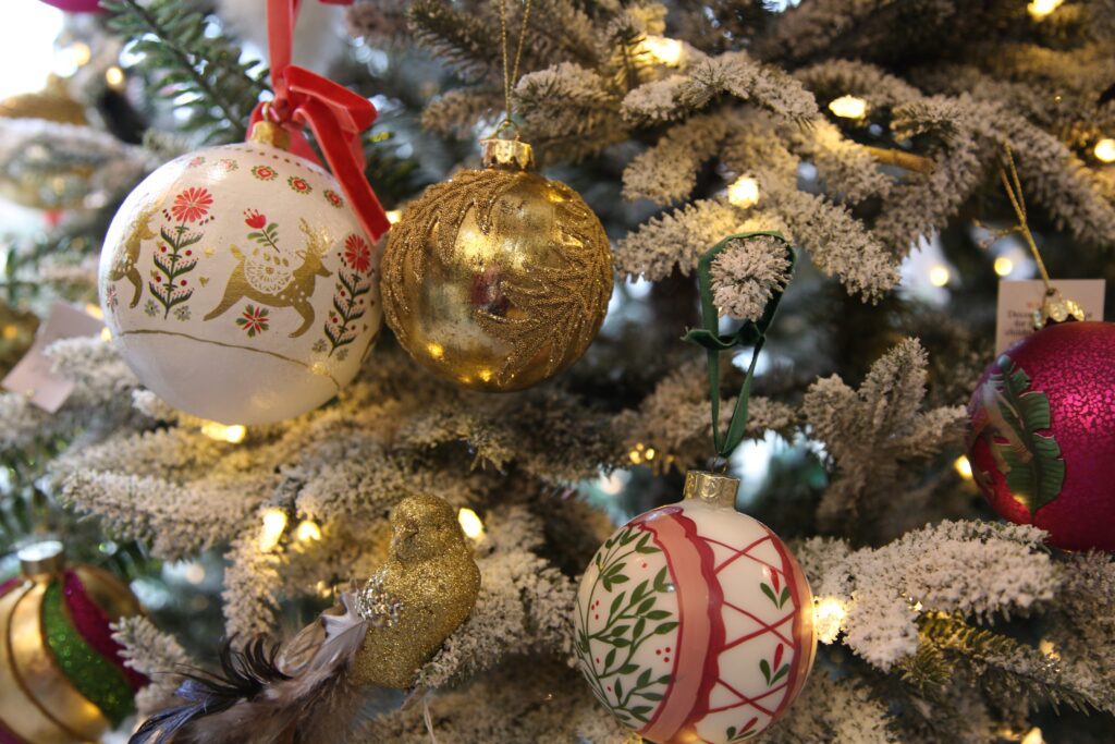 Gold glass beaded leaf bauble on christmas tree with other luxury christmas decorations