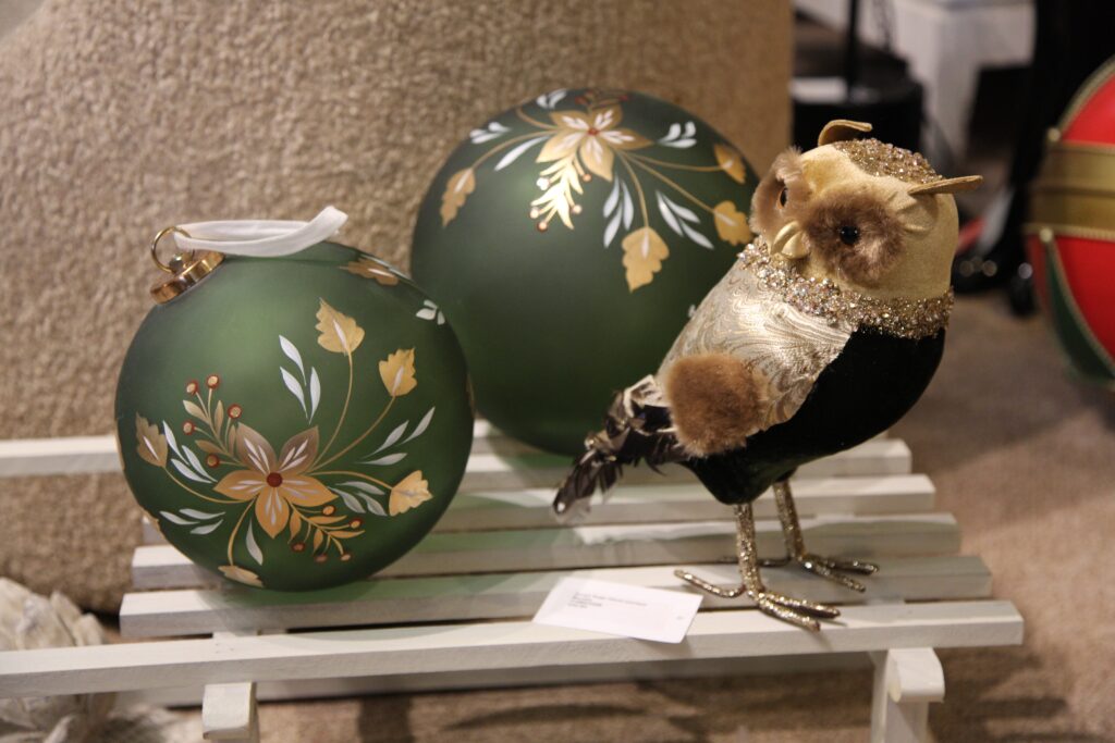 Extra large sage hand painted glass bauble next to a decorative christmas owl