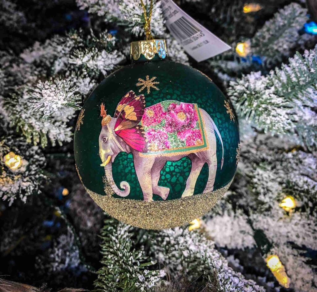 Antique green glass ball with elephant showing off the quirky christmas decorations